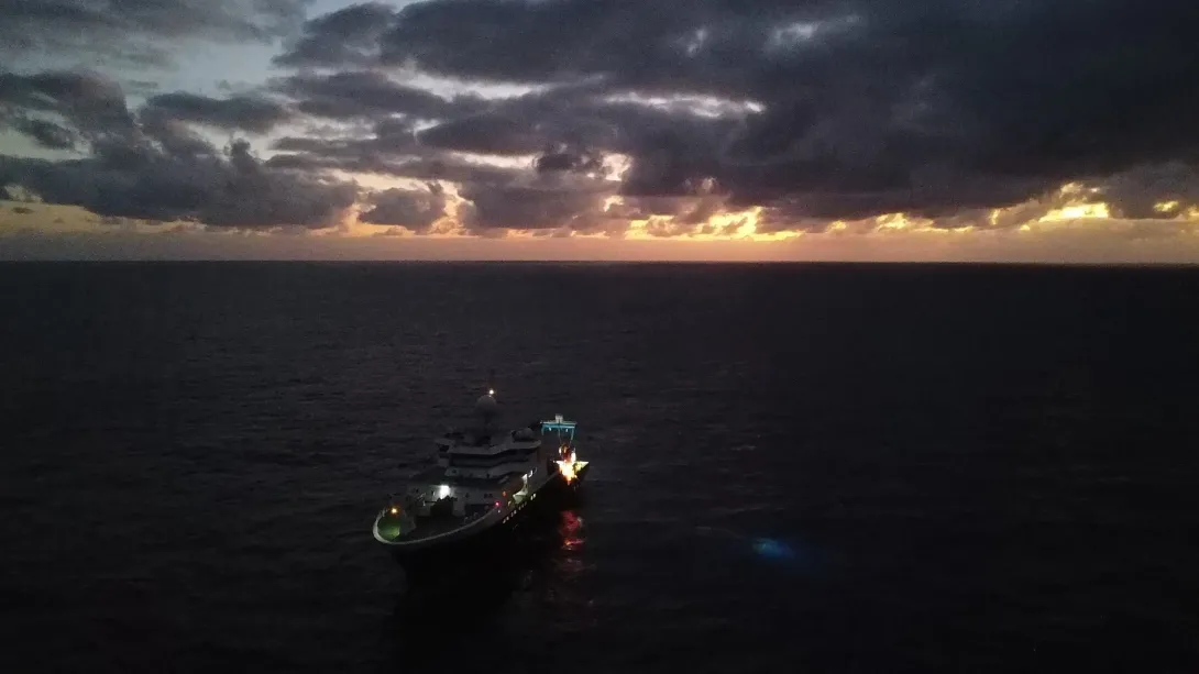 RRS James Cook with a cloudy sky above