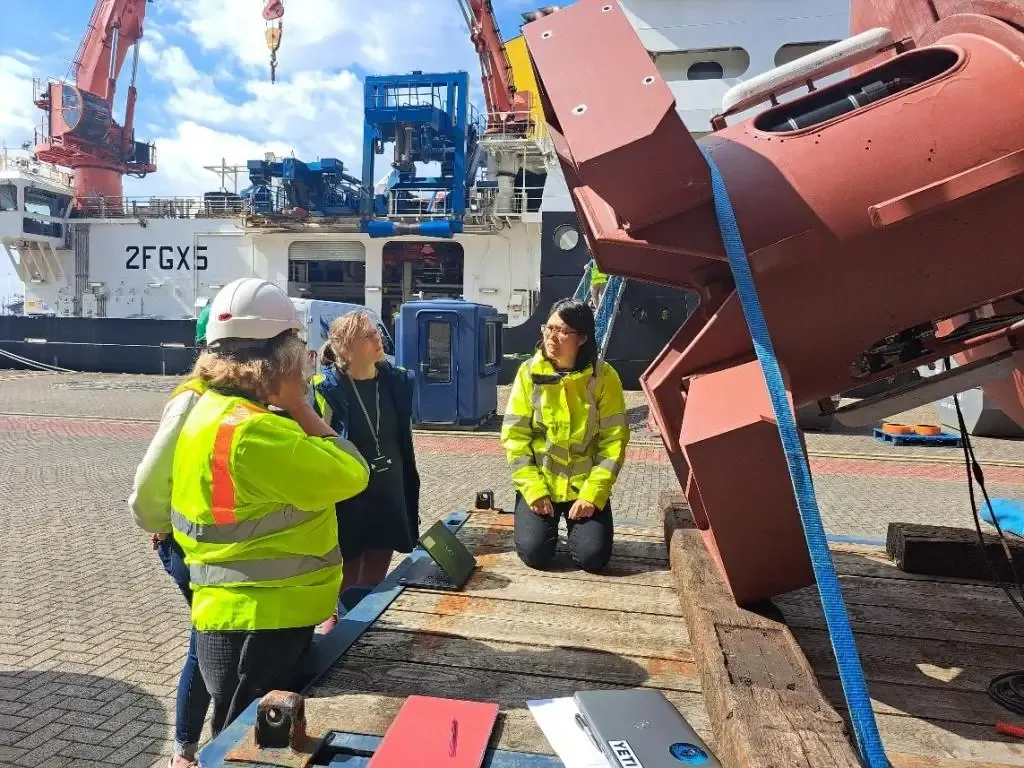 Setting up sensors in the keel of a surface ocean buoy.